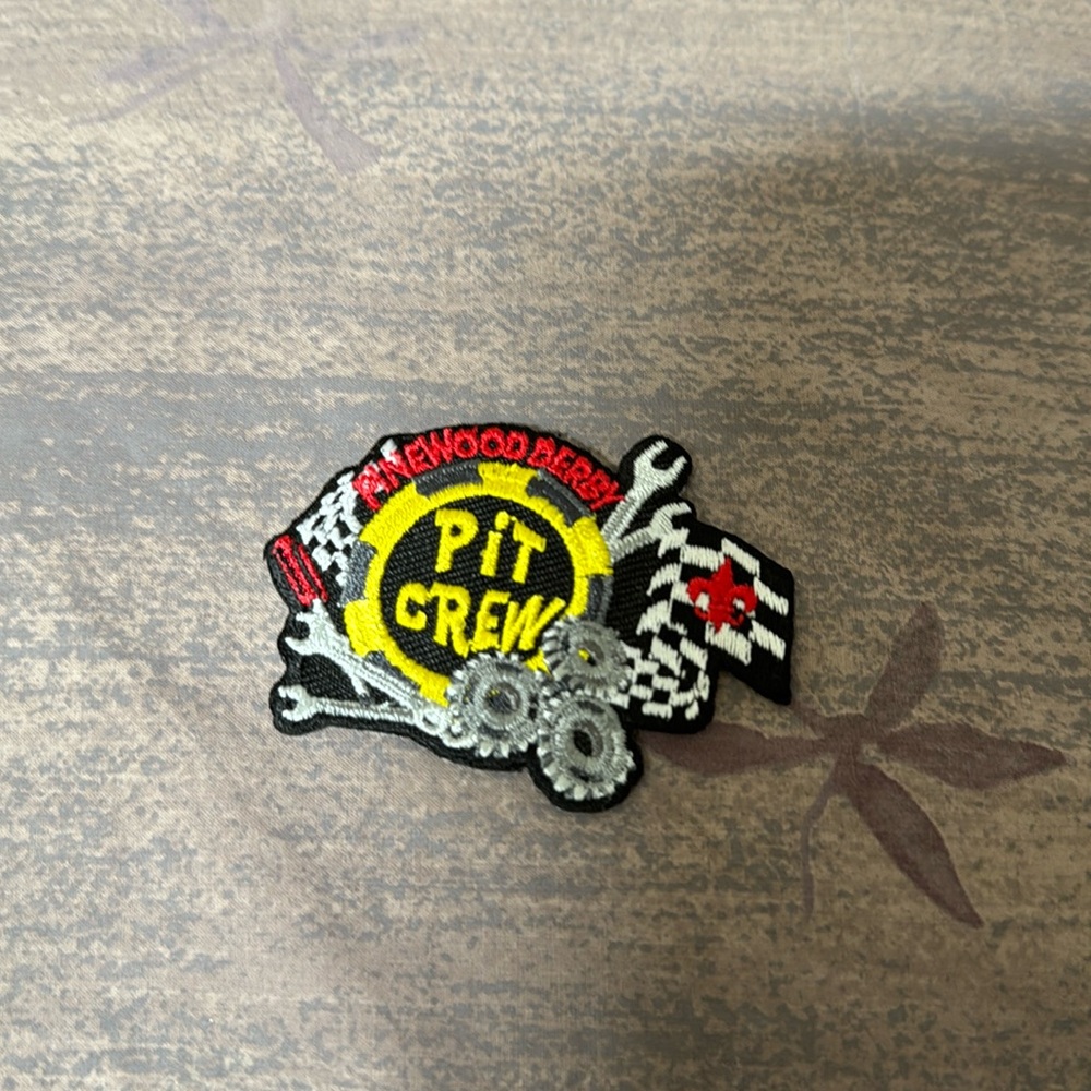New Pinewood Derby “pit crew” patch. Featuring a finish line flag and tools.